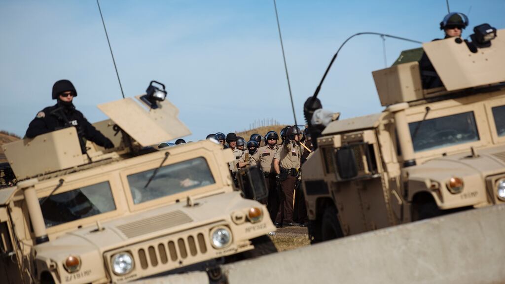 Police face off against protestors occupying a bridge immediately north of the Standing Rock Sioux Reservation. Photograph: Angus Mordant/The New York Times