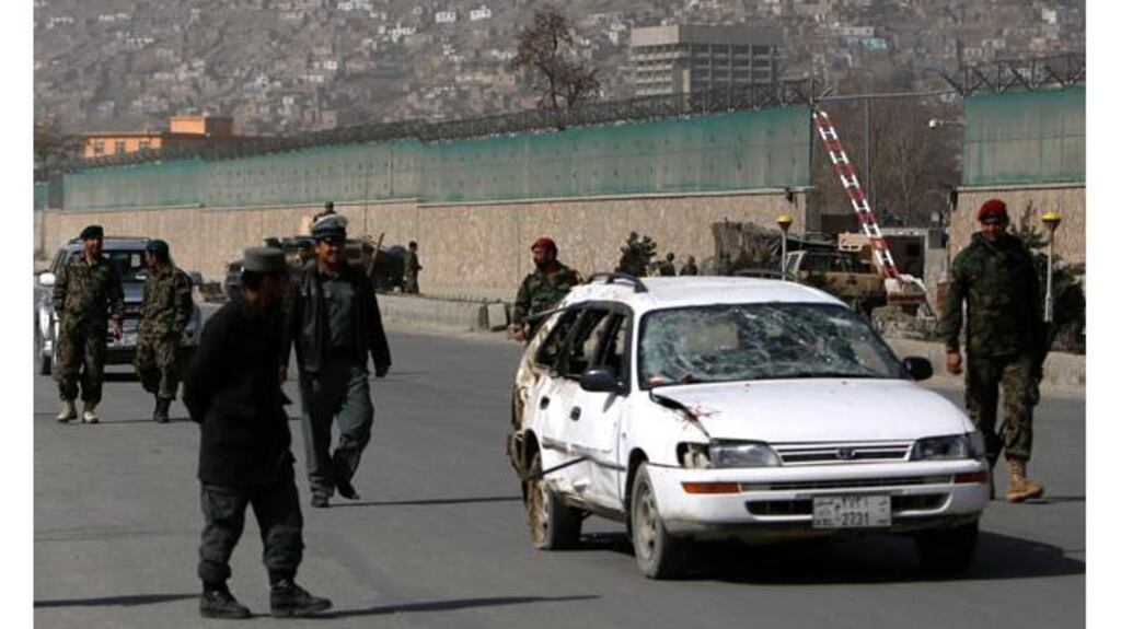 Afghan soldiers remove a damaged car from the site of a suicide attack in Kabul this morning. Photograph: Mohammad Ismail`/Reuters