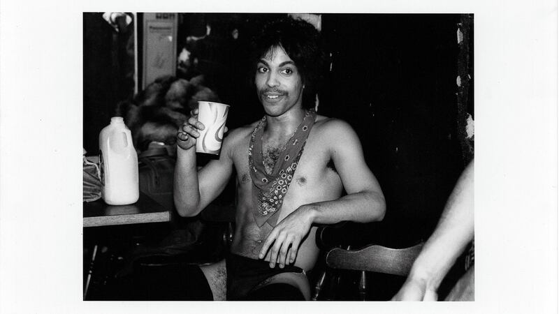 Prince sips some orange juice backstage during the Dirty Mind tour, 1981. Photograph: Allen Beaulieu