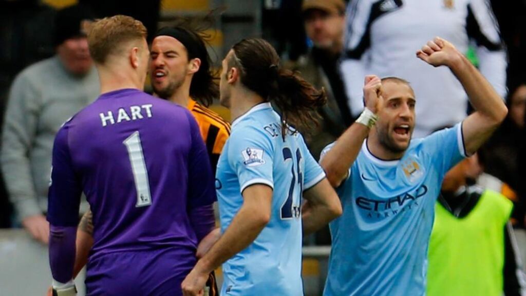 Goalkeeper Joe Hart of Manchester City and George Boyd of Hull City clash at KC Stadium. Photograph: Paul Thomas/Getty Images
