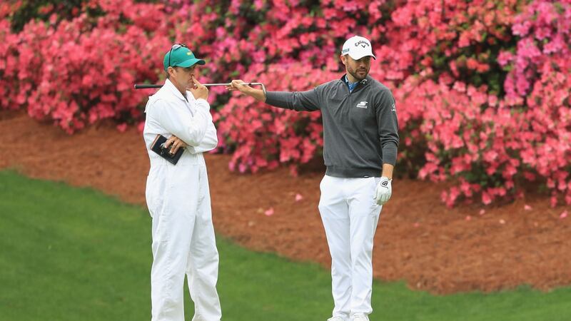 Wesley Bryan  talks with his caddie William Lanier on the 13th hole during a practice round prior to the start of the 2018 Masters. Photograph: Andrew Redington/Getty Images