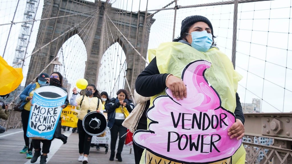 New York City street vendors march over the Brooklyn Bridge calling on the New York City Council to include street vendors in the city’s Covid-19 recovery efforts by passing a law, Intro 1116, that would lift the limits on the number of street permits. Photograph: Justin Lane/EPA.