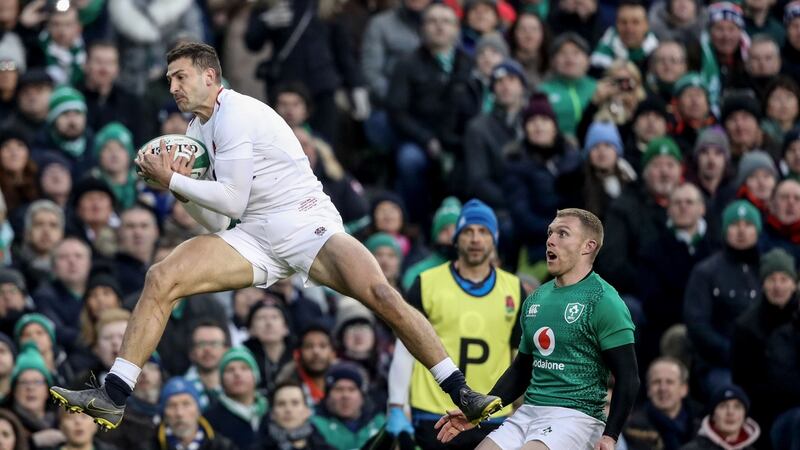England’s Jonny May catches the ball ahead of Ireland’s Keith Earls during the Six Nations match at the Aviva stadium. Photograph: Billy Stickland/Inpho