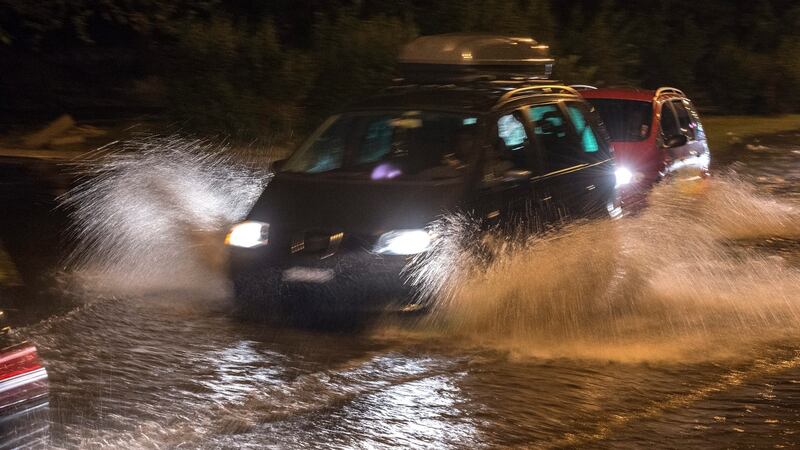 People drive cars through a flooded street in Skopje, Macedonia. Photograph: Georgi Licovski/EPA
