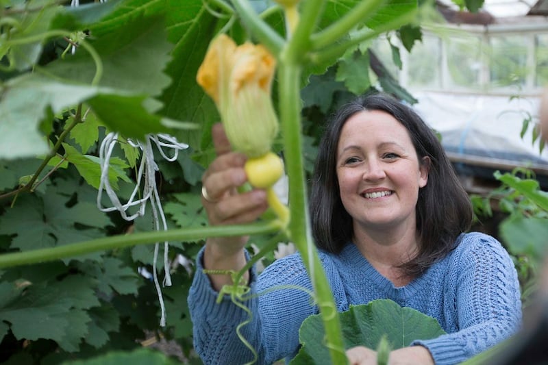 Gayle in the greenhouse.