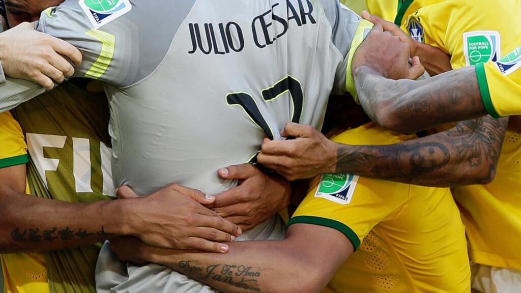 Brazilian players celebrate with goalkeeper Júlio César after winning the penalty shoot-out in the round of 16 match against Chile at the Estadio Mineirao in Belo Horizonte. Photograph: Dennis Sabangan/EPA