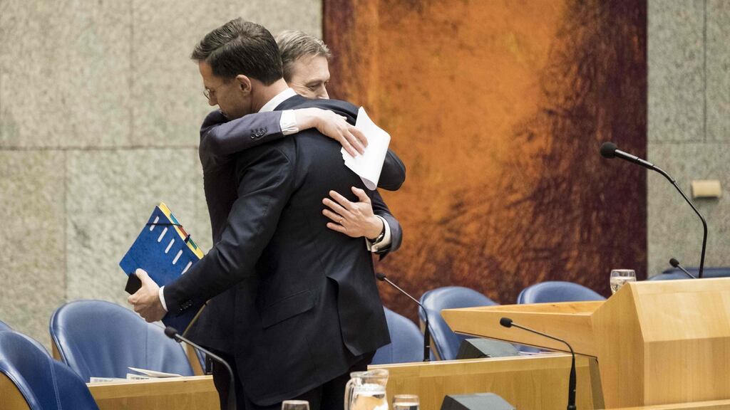Dutch foreign minister Halbe Zijlstra hugs prime minister Mark Rutte after announcing his resignation in the Dutch parliament on Tuesday. Photograph: Martijn Beekman/AFP/Getty Images
