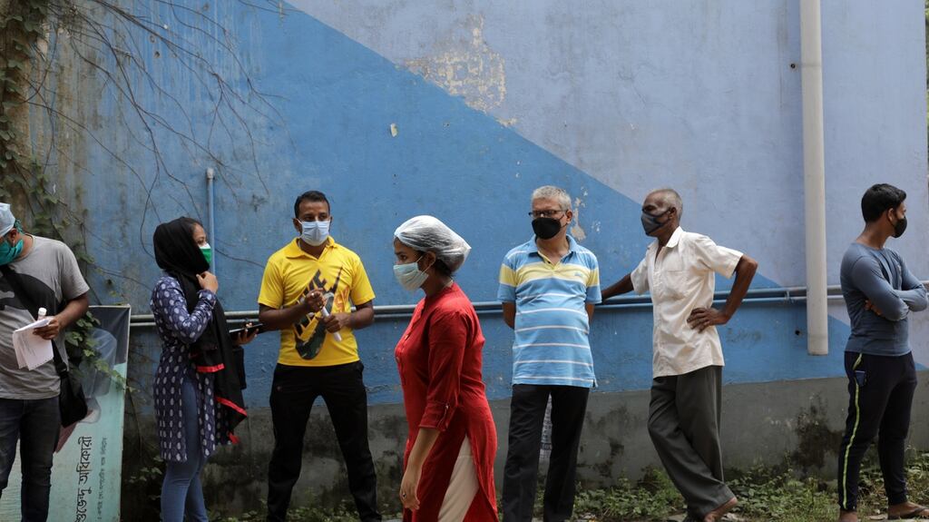Locals wear protective face masks at government test centre in Kolkata, eastern India on Monday. Photograph: Piyal Adhikary/EPA