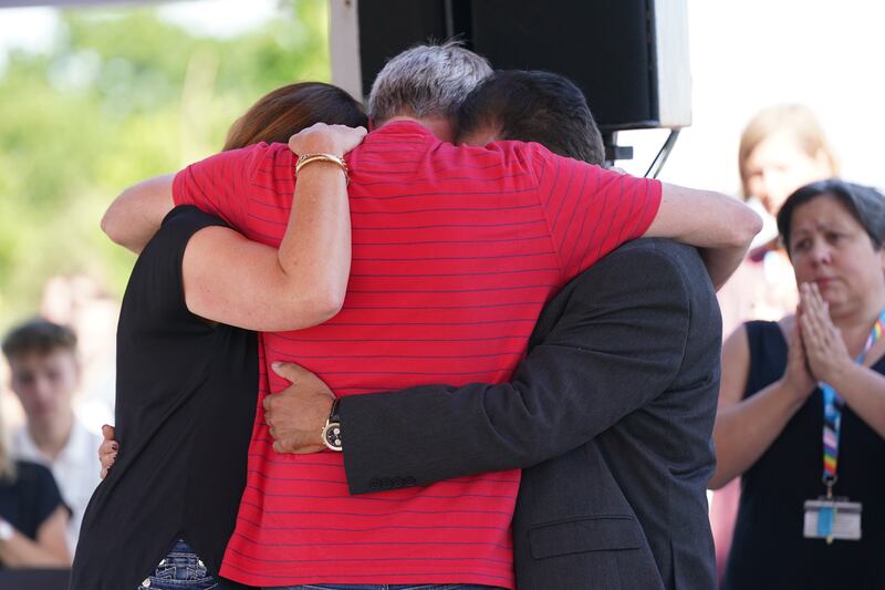Grace O'Malley Kumar's father (right) and Barnaby Webber's parents embrace during a vigil at the University of Nottingham on Wednesday. Photograph: Jacob King/PA Wire