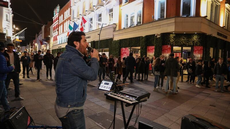 City centre revellers enjoy some last minute socialising on Dublin’s Grafton Street before Level 5 lockdown started at midnight. Photograph: Crispin Rodwell