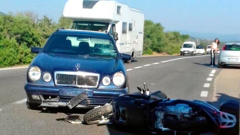 A scooter lies next to a car following a crash in Sardinia. Photograph: Mario Chironi/AP