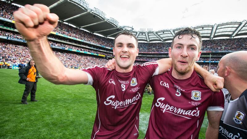 Johnny Coen and Padraic Mannion celebrate after the game. Photo: Cathal Noonan/Inpho