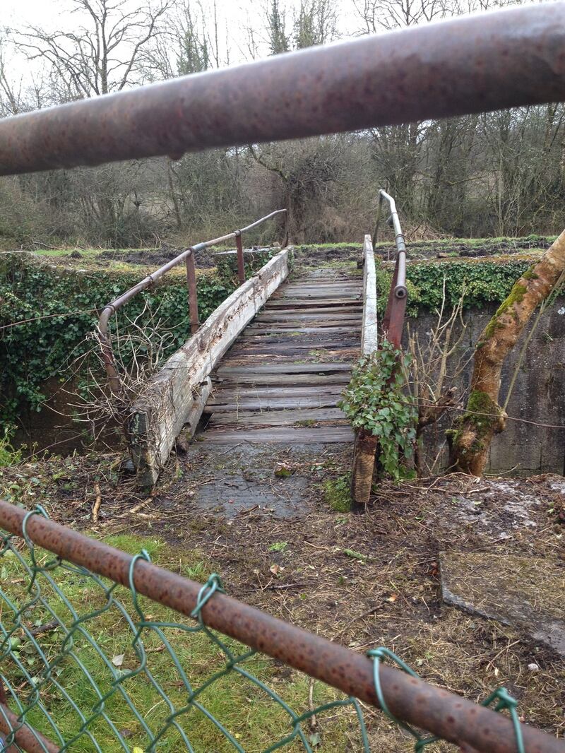 The disused Clonaheenoge Canal contains a dilapidated lock and the wooden struts of a rickety bridge, lying mildewed with broken gates