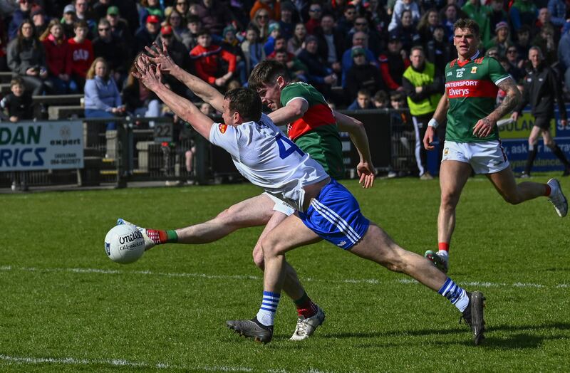 Mayo’s Frank Irwin kicks a point under pressure from Ryan Wylie of Monaghan. Photograph: INPHO/John Corless