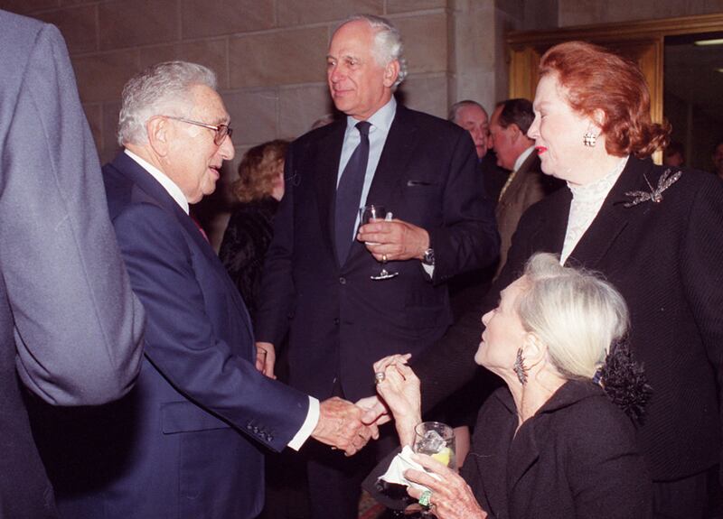 Evelyn de Rothschild, center, mingles with, clockwise from right, Sheila de Rochambeau, Nan Kempner and Henry Kissinger at a party in New York in January 2004. Photograph: Bill Cunningham/The New York Times