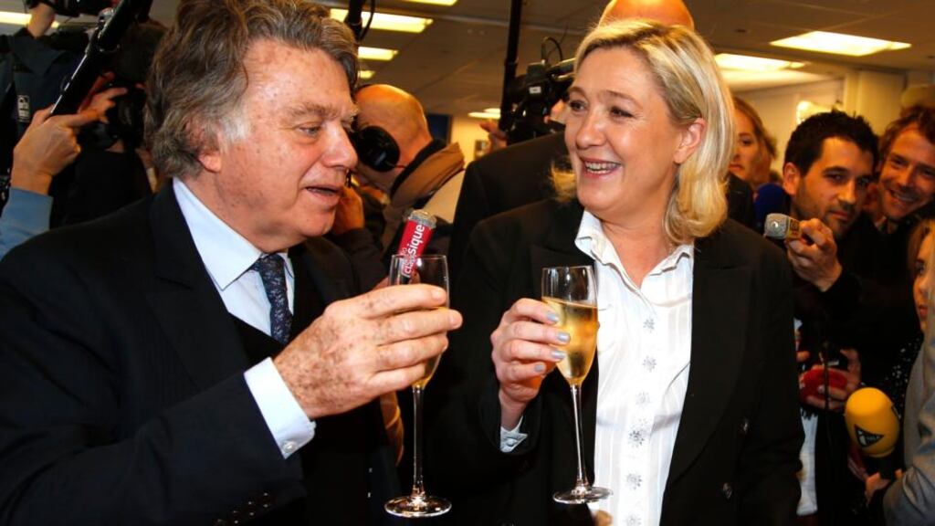 Marine Le Pen and National Front  deputy Gilbert Collard hold glasses with champagne surrounded by journalists as they attend the presentation of New Year wishes to the media in Nanterre on Tuesday. Photograph: Benoit Tessier/Reuters