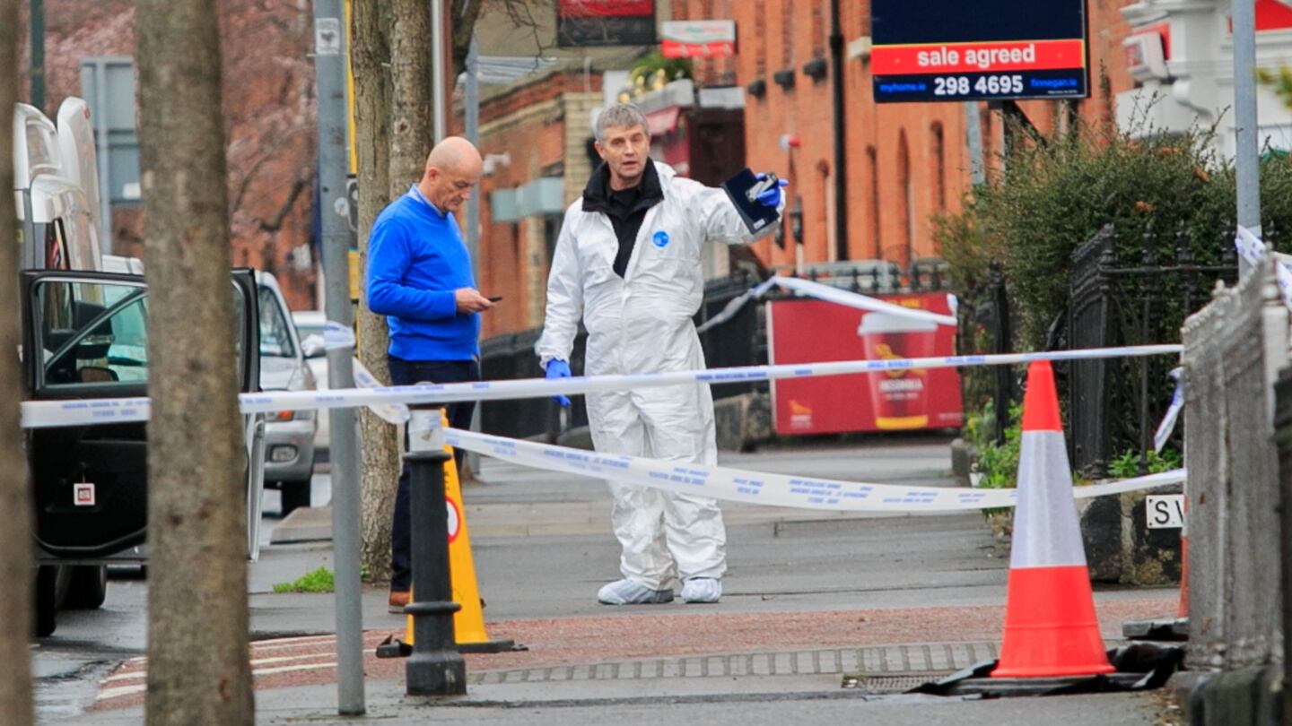 Forensic experts examine the scene of the shooting. Photograph: Collins