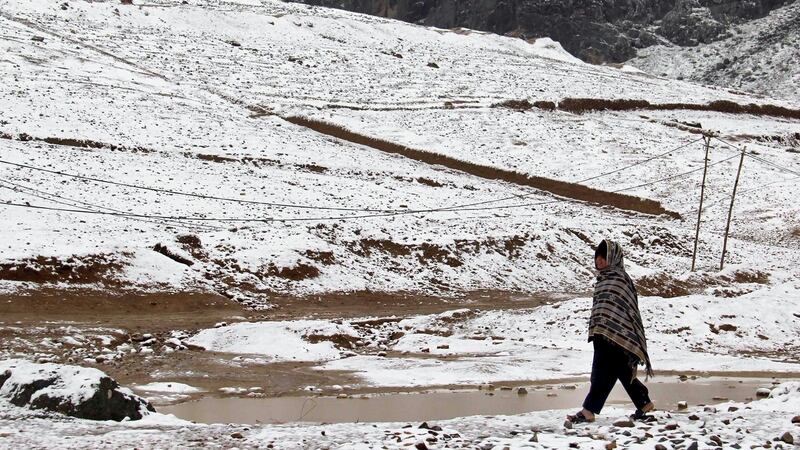 A man walks on a snow covered path in Kandahar, Afghanistan on Sunday. Photograph: Muhmmad Sadiq/EPA