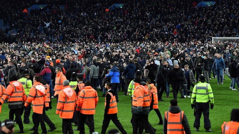Aston Villa fans invade the pitch after their win over Leicester City. Photograph: Getty Images
