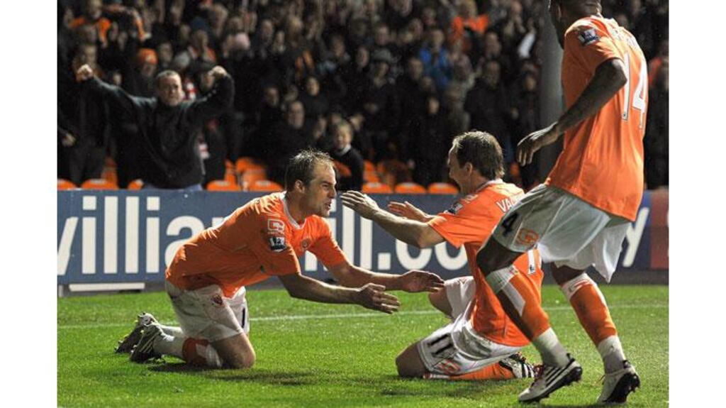 Blackpool's Luke Varney (left) celebrates with team-mate David Vaughan (centre) after scoring what turned out to be his side's winner against West Brom at Bloomfield Road (Photograph: PA)