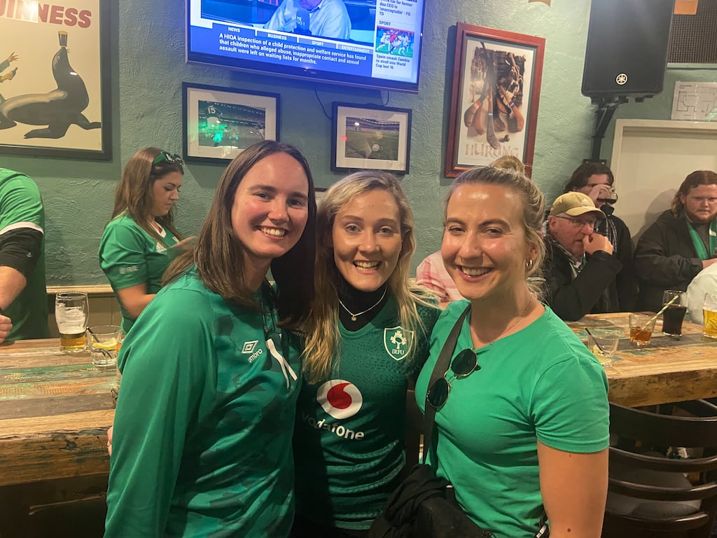 Meghan Carter, left, who quit her job to join the green army, in an Irish pub with friends before the match.