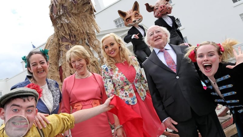 President Michael D Higgins and his wife Sabina with Emma O ‘Driscoll join Macnas outside the Áras in the Phoenix Park for the first of the summer garden parties. Photograph: Maxwells/Julien Behal