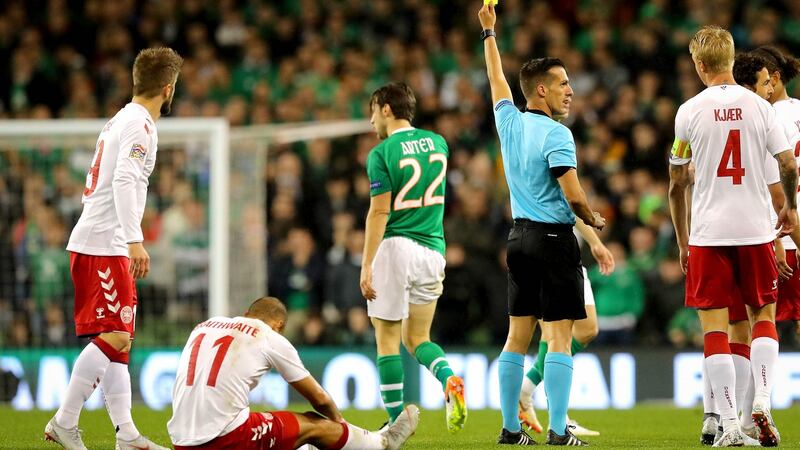 Harry Arter is shown a yellow card after eight minutes for a late challenge on Denmark’s Martin Braithwaite. Photograph: Ryan Byrne/Inpho