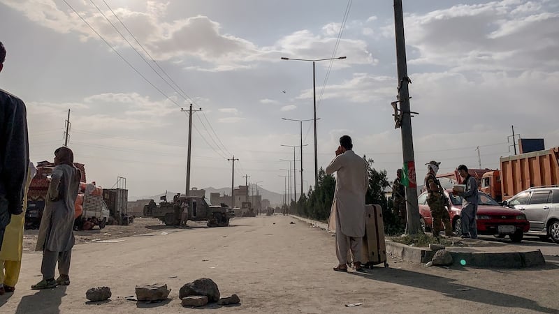 People gather near Kabul airport. Photograph: Jim Huylebroek/The New York Times