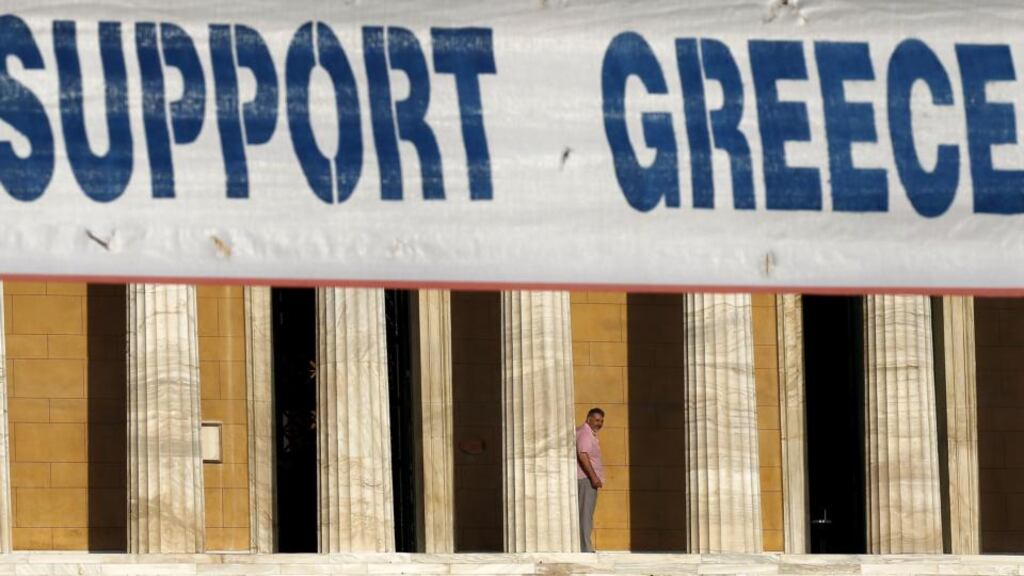 A banner hangs in front of the Greek parliament during a pro-government rally calling on Greece’s European and IMF creditors to soften their stance in the cash-for-reforms talks in Athens. Photograph: Yannis Behrakis/Reuters