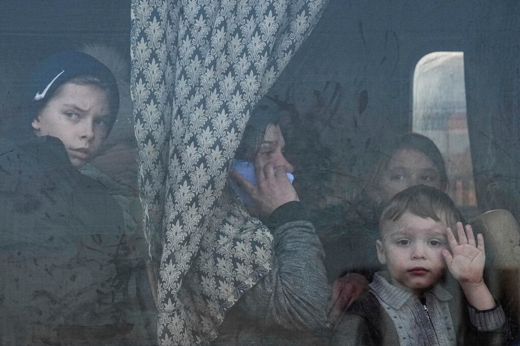 Internally displaced people look out from a bus at a refugee centre in Zaporizhia, Ukraine last year. Photograph: Evgeniy Maloletka/AP/PA