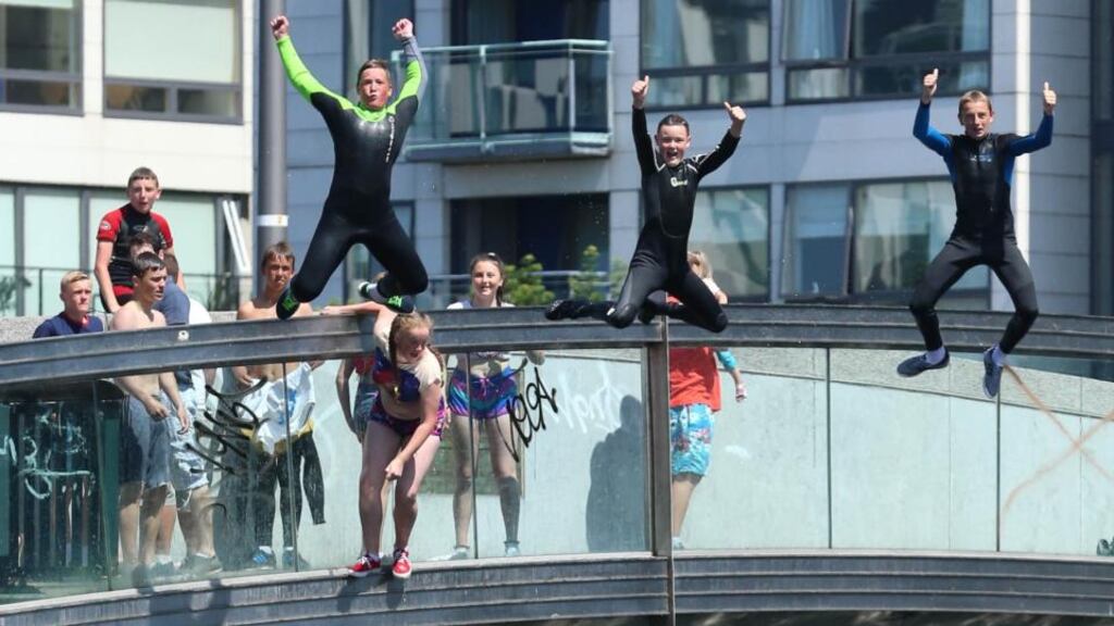 Teenagers jump into Grand Canal Dock in Dublin city centre. Photograph: Niall Carson/PA Wire