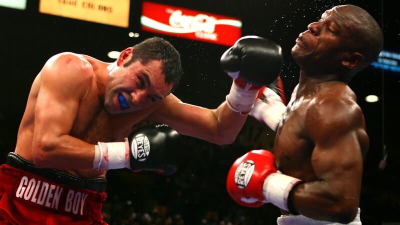 Oscar De La Hoya connects with a left to the face of Floyd Mayweather Jr during their WBC super welterweight championship fight at the MGM Grand Garden Arena in Las Vegas on May 5th, 2007. Photograph: Al Bello/Getty Images