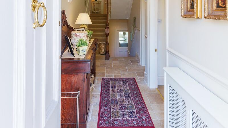 The front door opens into a hall of unhoned travertine