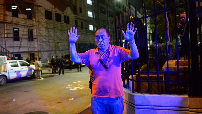 A Filipino man is frisked by a policeman outside the Resort World Manila hotel in Pasay city, south of Manila. Photograph: EPA