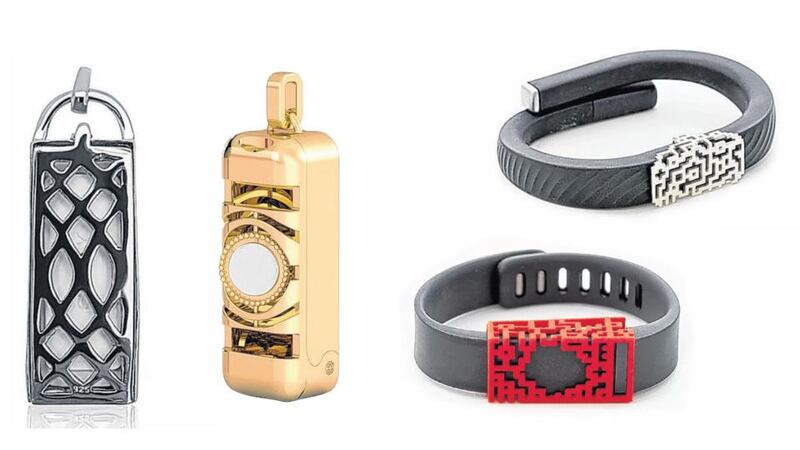 Fitjewels silver pendant (with chain not pictured) add-on for Sony SmartBand, €128; Blingtec 18-carat gold-finished pendant (with leather lariat, not pictured) for Fitbit Flex €166; Bytten silver-tone add-on for Jawbone, €50 (sale price); and Bytten 3D-printed red add-on for Fitbit, €13.82