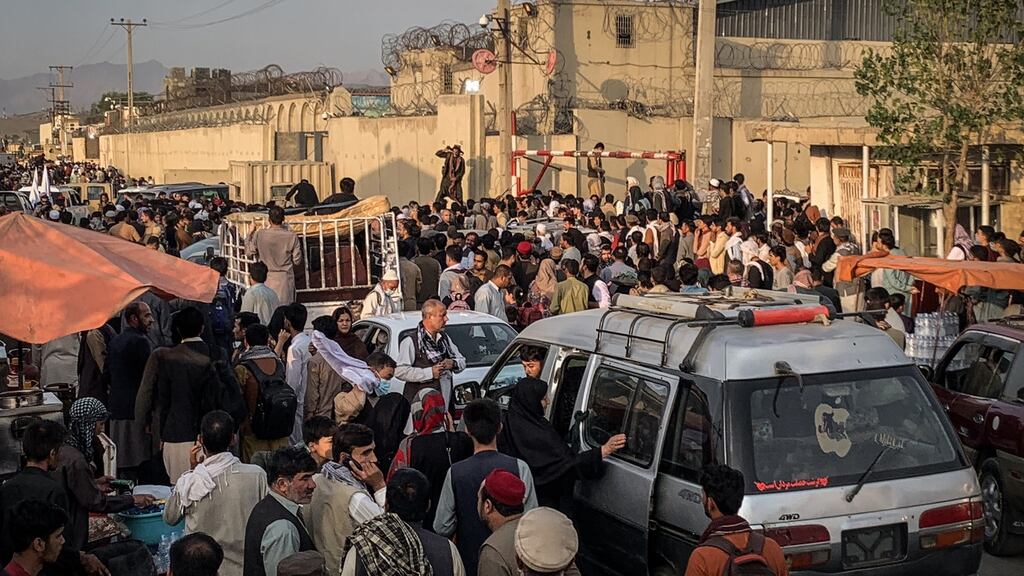 Hoping to flee the country, people gather near the airport in Kabul on Saturday. Photograph: Jim Huylebroek/The New York Times