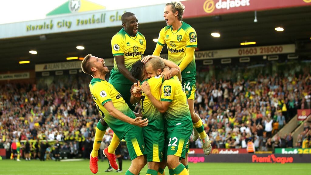 Norwich City striker Teemu Pukki celebrates with team-mates after scoring his team’s third goal during the Premier League match against Manchester City at Carrow Road. Photograph: Marc Atkins/Getty Images