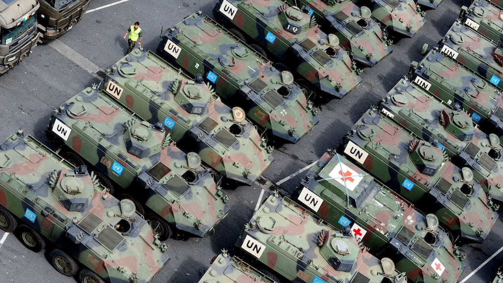 A member of the Defence Forces walks through Mowag Armoured Personnel Carriers in Dublin Port after they were shipped home from the Minurcat mission in Chad in 2010. File photograph: The Irish Times.
