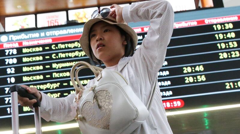 A young Chinese tourist in Moscow at Leningradsky Railway Station. File photograph: Anton Novoderezhkin/Tass/Getty Images)