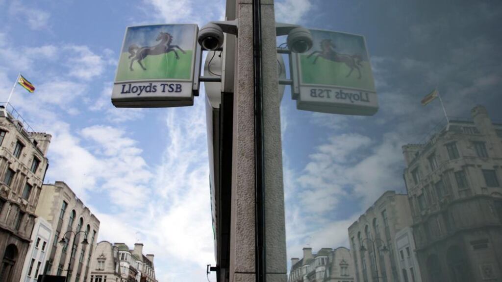 A sign from a branch of a Lloyds bank is reflected in a window in central London. Lloyds share rose 2.5 per cent to reach 62.5 pence at noon on Friday, passing the 61.2 pence point the UK government sees as its break-even price, raising hopes of a sale this year. Photograph: Reuters/Stefan Wermuth