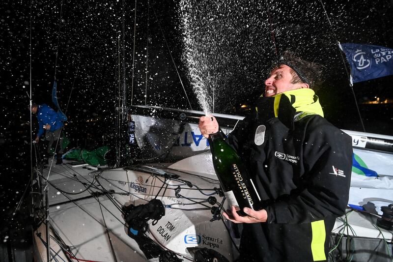 Tom Dolan sprays champagne after crossing the finish line in La Turballe to win the Solitaire du Figaro. Photograph: Sebastien Salom-Gomis/AFP via Getty Images