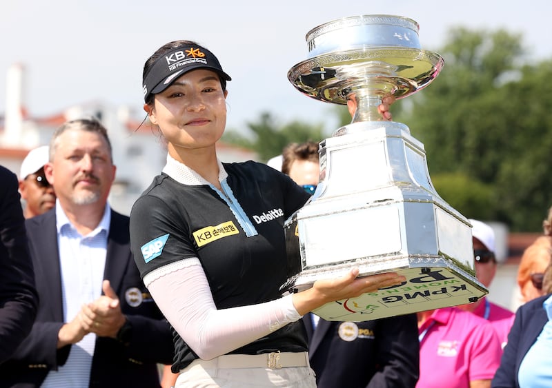 In Gee Chun of South Korea poses with the championship trophy at Congressional Country Club