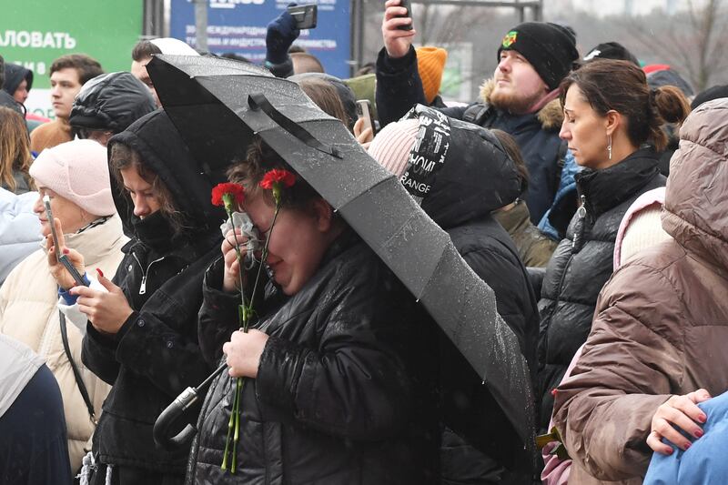 A woman griefs at a makeshift memorial in front of the Crocus City Hall in Krasnogorsk Photograph: Olga Maltseva/AFP via Getty Images