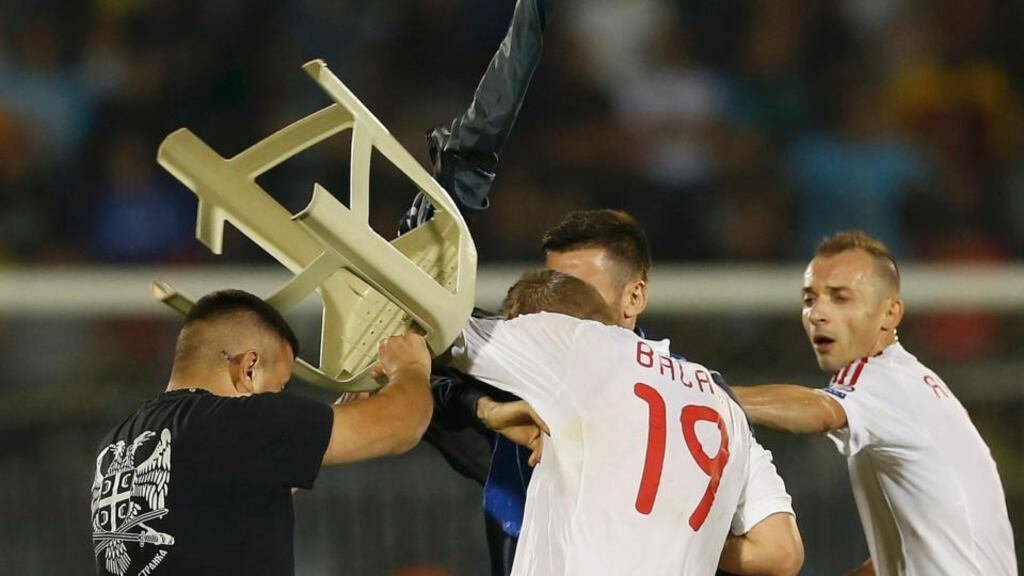 A Serbian fan attacks Albania’s Bekim Balaj with a chair during disturbances at te Euro 2016 qualifier between Serbia and Albania in Belgrade on Tuesday night. Photograph: Marko Djurica/Reuters