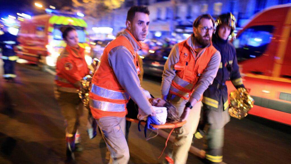 A woman is evacuated from the Bataclan theatre after the terror attack in Paris on November 13th, 2015. Photograph: Thibault Camus/AP