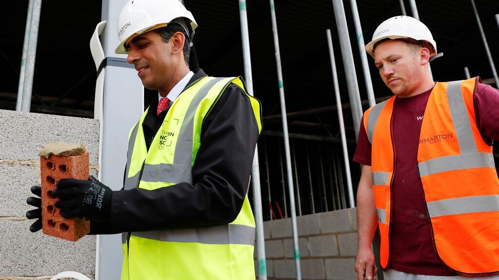 Chancellor of the UK exchequer Rishi Sunak attempts bricklaying with Danny Honeyman at a construction area during a local election campaign visit to Northern School of Art last week in Hartlepool, England. Photograph: Lee Smith - WPA Pool/Getty Images