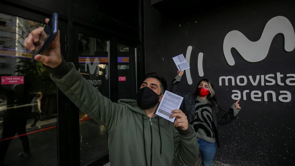 A couple taking a photograph with their health books after getting vaccinated in the Buenos Aires neighbourhood of Villa Crespo in Argentina. Photograph: EPA/Demian Alday Estevez