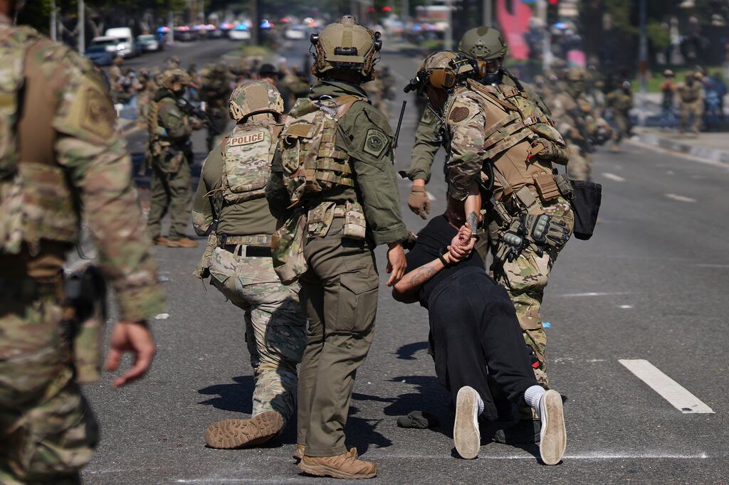 Police detain a man during a protest in Paramount, Los Angeles. Photograph: Eric Thayer/AP