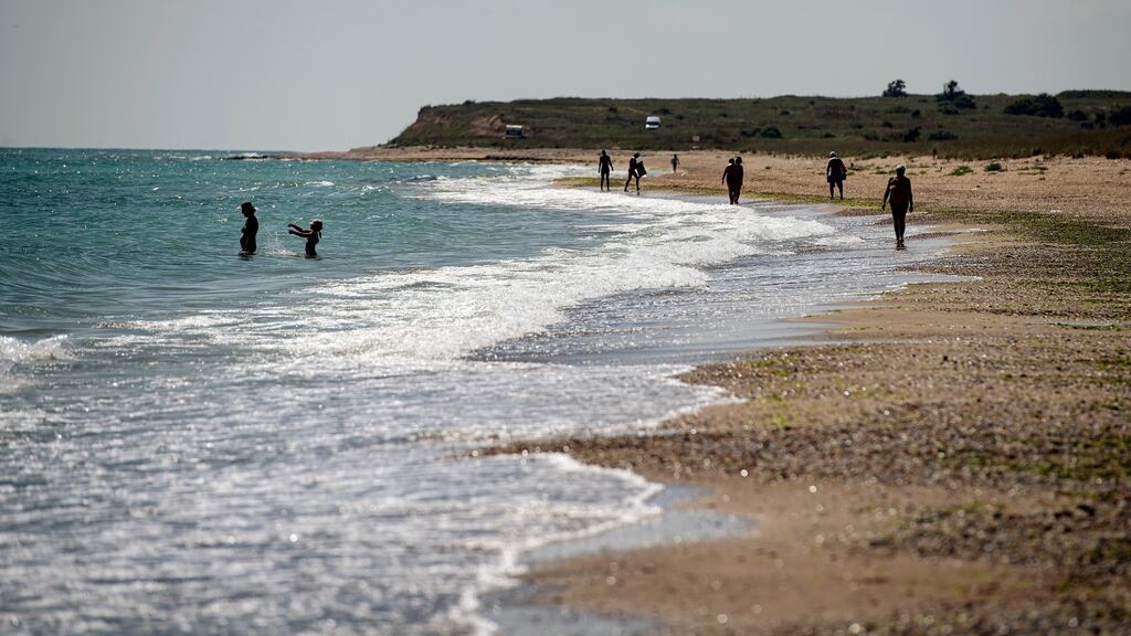 People walk on the beach near Shabla, Bulgaria. WHO special envoy Dr David Nabarro has advised caution on overseas travel. Photograph: Vassil Donev/EPA