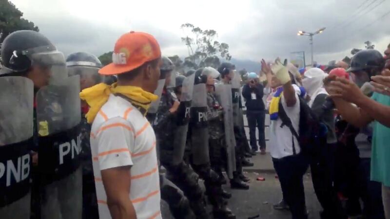 Demonstrators confront police in the Venezuelan capital. Photograph: Reuters